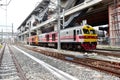 The Trains running on the train tracks to the station in Thailand