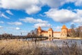 Trakai Island Castle orange walls and towers, lake Galve Royalty Free Stock Photo