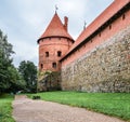 Landscape of ancient Trakai Island Castle with road and tree, Lithuania. Trakai Island Castle and dramatic sky with clouds Royalty Free Stock Photo