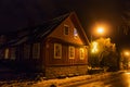 TRAKAI, LITHUANIA - DECEMBER 26, 2018: Night view of old residential wooden house at winter time in Trakai