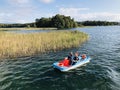 Tourist family are enjoying pedal boat to sightseeing in the Lake Galve surrounding the Trakai Island Castle in Trakai, Lithuania.