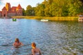 TRAKAI/LITHUANIA: 09/07/2019: Two young girls are swimming i in clear water of Galve lake, Trakai Historical National Park, UNESCO