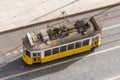 Tram from above on the streets of Lisbon, a classic traditional yellow trolley tram 28 Portugal.