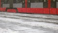 Tram arriving to the frozen platform during storm