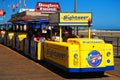 A tram car stops to pick up passengers