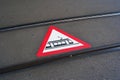 Tram crossing warning sign or pictogram painted on the asphalt road between train tracks in a city in Europe. No people Royalty Free Stock Photo