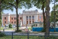 Tram and cyclist pass a Gothenburg University building