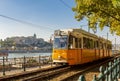 Tram on Danube embankment with Royal palace at background, Budapest, Hungary