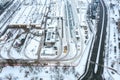Tram depot in winter foggy day. urban industrial district with snow-covered buildings. aerial view