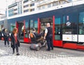 A tram driver helps a person with disabilities enter a tram in an electric wheelchair.