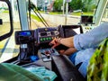 Tram driver at work drives a tram in the summer in the city