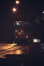 a tram is filled with passengers during a heavy snowfall at night in the city on a cobbled street Royalty Free Stock Photo