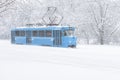 Tram goes along the street during snowstorm in Moscow