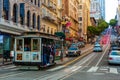 Tram with a group of people on it on a road going uphill in San Francisco, California