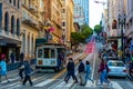 Tram with a group of people on it on a road going uphill in San Francisco, California