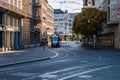 A tram heading for the Paradeplatz over winding tram tracks on a sunny day in autumn