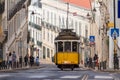 Tram 28 on a hill in Lisbon, Classic traditional yellow trolley