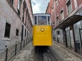 Tram in Lisbon city. Famous retro yellow funicular tram on narrow streets of Lisbon Royalty Free Stock Photo