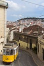 Tram in Lisbon with cityscape and Sao Jorge castle in the back, Portugal Royalty Free Stock Photo