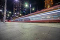 Tram moving through George St at night leaving colourful light trails Sydne