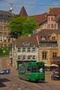 Green tram No 16 on cable & track in Basel with traditional building houses, Switzerland