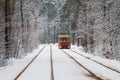 Tram number 12 on the route in a snow-covered forest in Kyiv. Ukraine