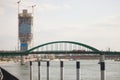 Tram passing by stari savski most bridge over sava river with construction of Belgrade waterfront, or Beograd na vodi, behind. Royalty Free Stock Photo