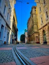 Tram rails in the streets of Timisoara city in Romania alongside the small buildings on a sunny day Royalty Free Stock Photo