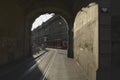 Tram railway tunnel under the baroque tower Kafigturm on a historical cobbled street.