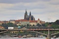 Tram rides on the bridge against the background of Prague Castle