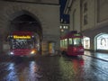 Tram rushes at night in front of the historic Zytglogge (clock tower) in Bern