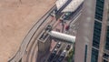 Tram station in Dubai Marina with footbridge aerial timelapse