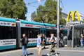 tram stop South Station, people waiting for desired transport route, McDonald\'s sign over stop