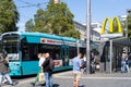 tram stop South Station, people waiting for desired transport route, McDonald\'s sign over stop