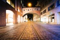 Tram tracks and arch on MaffeistraÃÅ¸e at night, in Munich, Germany.