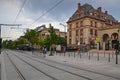 Tram tracks & cables for Ile-de-France tramways in front of Cite internationale universitaire de Paris building in Paris, France Royalty Free Stock Photo