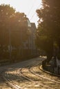 Tram tracks on stone-paved road at sunset. Old european street of Poznan, Poland in summer time. Tram rails at sunshine. Royalty Free Stock Photo