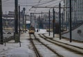 Tram on the tracks. Winter landscape on the background of an industrial landscape