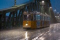 Tram under heavy night rain