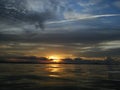 tramonto arancione con nuvole su specchio d'acqua Royalty Free Stock Photo
