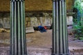 Tramp sleeping under bridge, Regent's Park, London