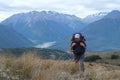 Tramper walks uphill in the mountains