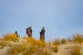 Tramping group on Sand dunes and surf waves in bay