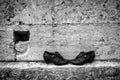 Trampled discarded shoes against the background of a limestone wall. Still life. Black and white Royalty Free Stock Photo