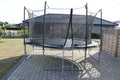 Trampoline. Jumping trampoline. Outdoor trampoline with safety net.
