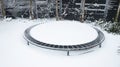 A trampoline with snow on it.