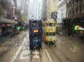 Trams in Hong Kong through wet window Royalty Free Stock Photo