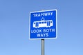 Tramway look both ways tram rail safety sign against blue sky