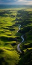 Tranquil Aerial View Of Luminescent River Flowing Through Grassy Hills Royalty Free Stock Photo