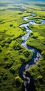 Tranquil Aerial View Of A Serene River Flowing Through A Lush Green Field Royalty Free Stock Photo